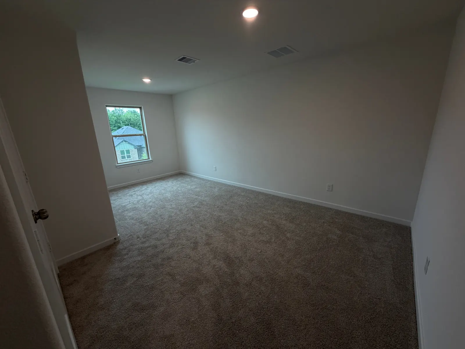 Carpeted bedroom with window at 11830 Serena's Song Drive, Willis, TX