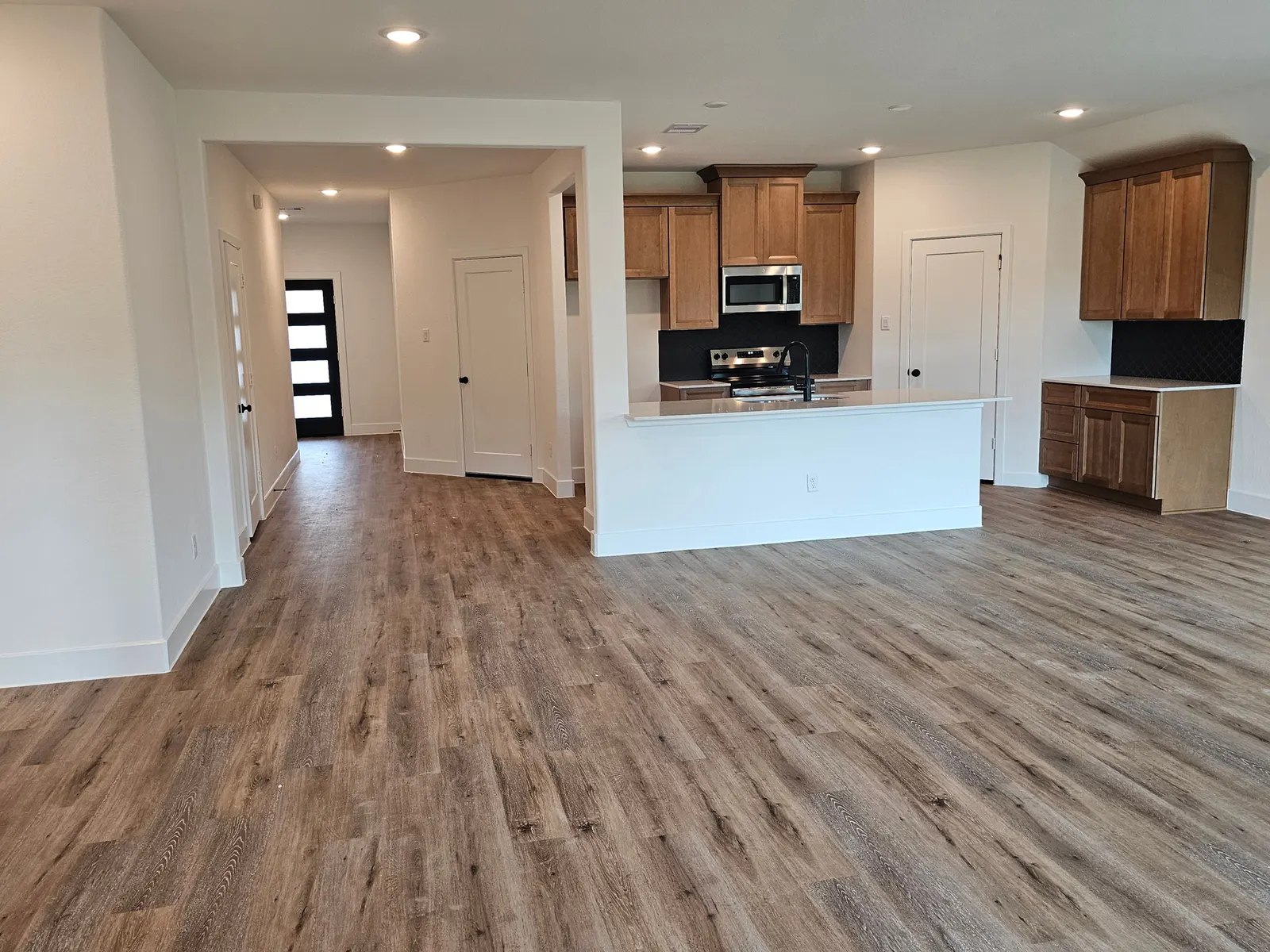 Open living area looking toward the kitchen at 10727 Crockett Meadows, Conroe, TX