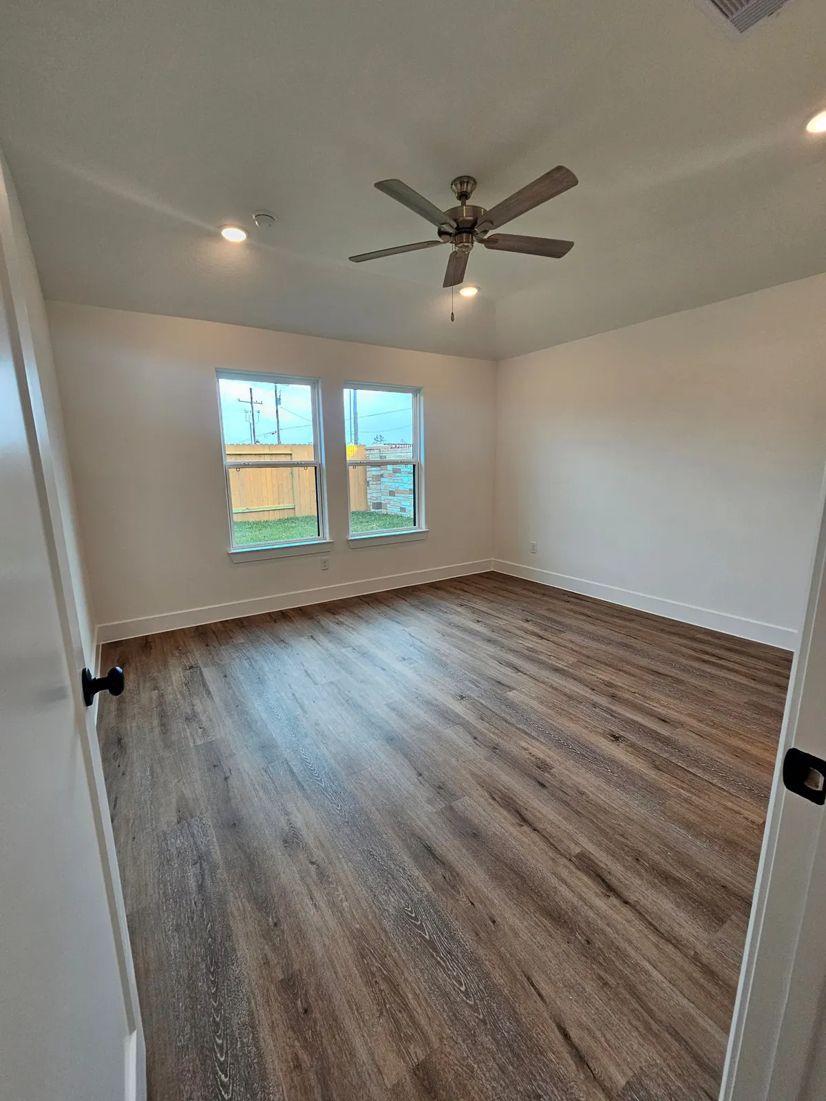 Primary bedroom with windows at 10727 Crockett Meadows, Conroe, TX