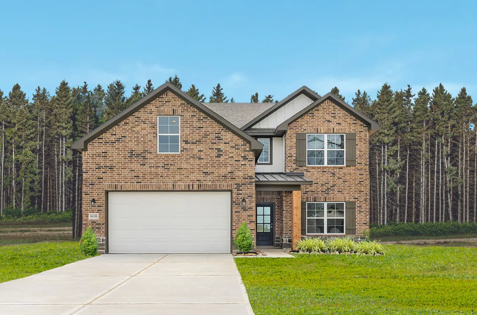Two-story brick home with a covered entry and two-car garage
