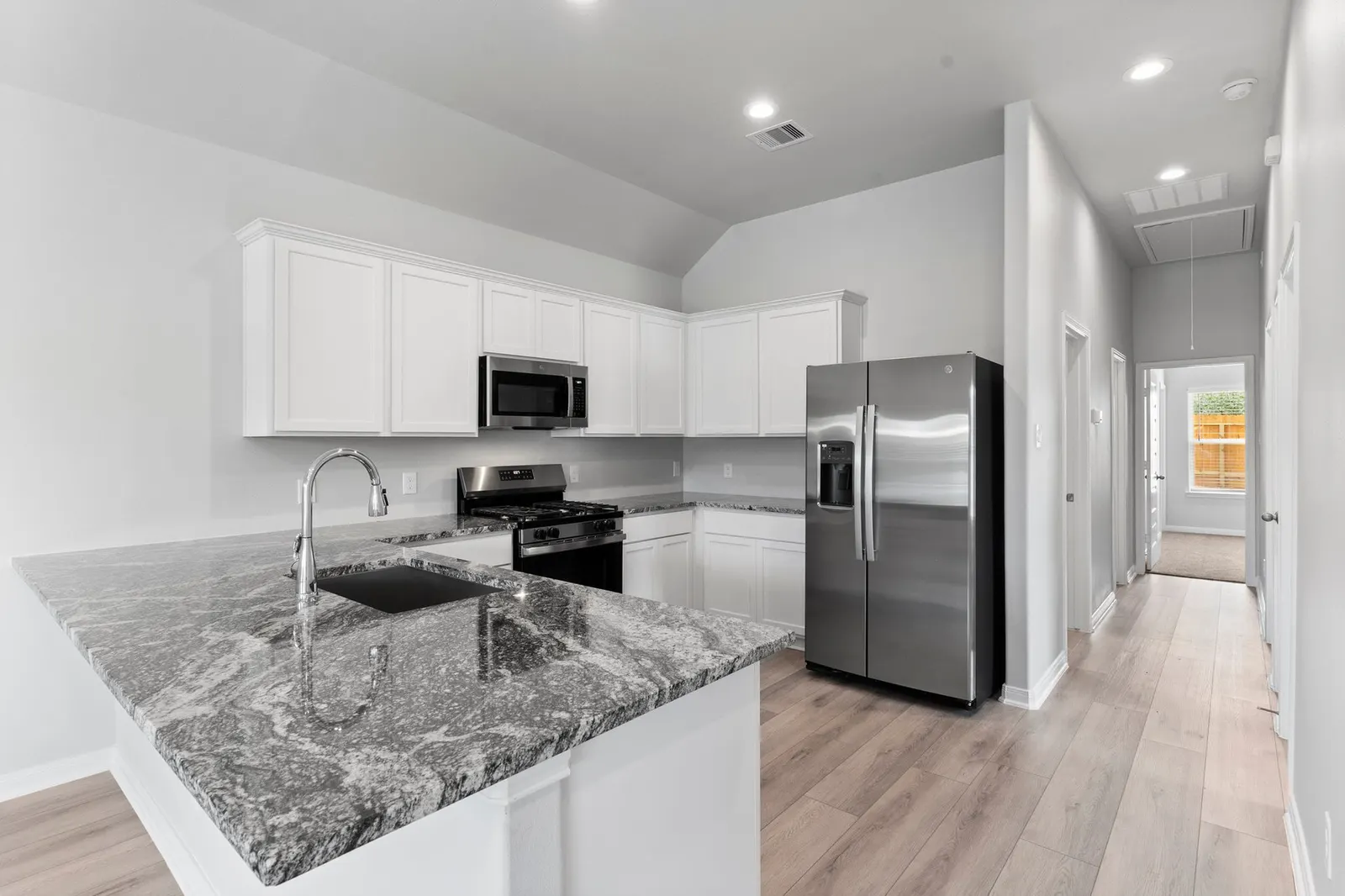 Kitchen with white cabinets and granite counters