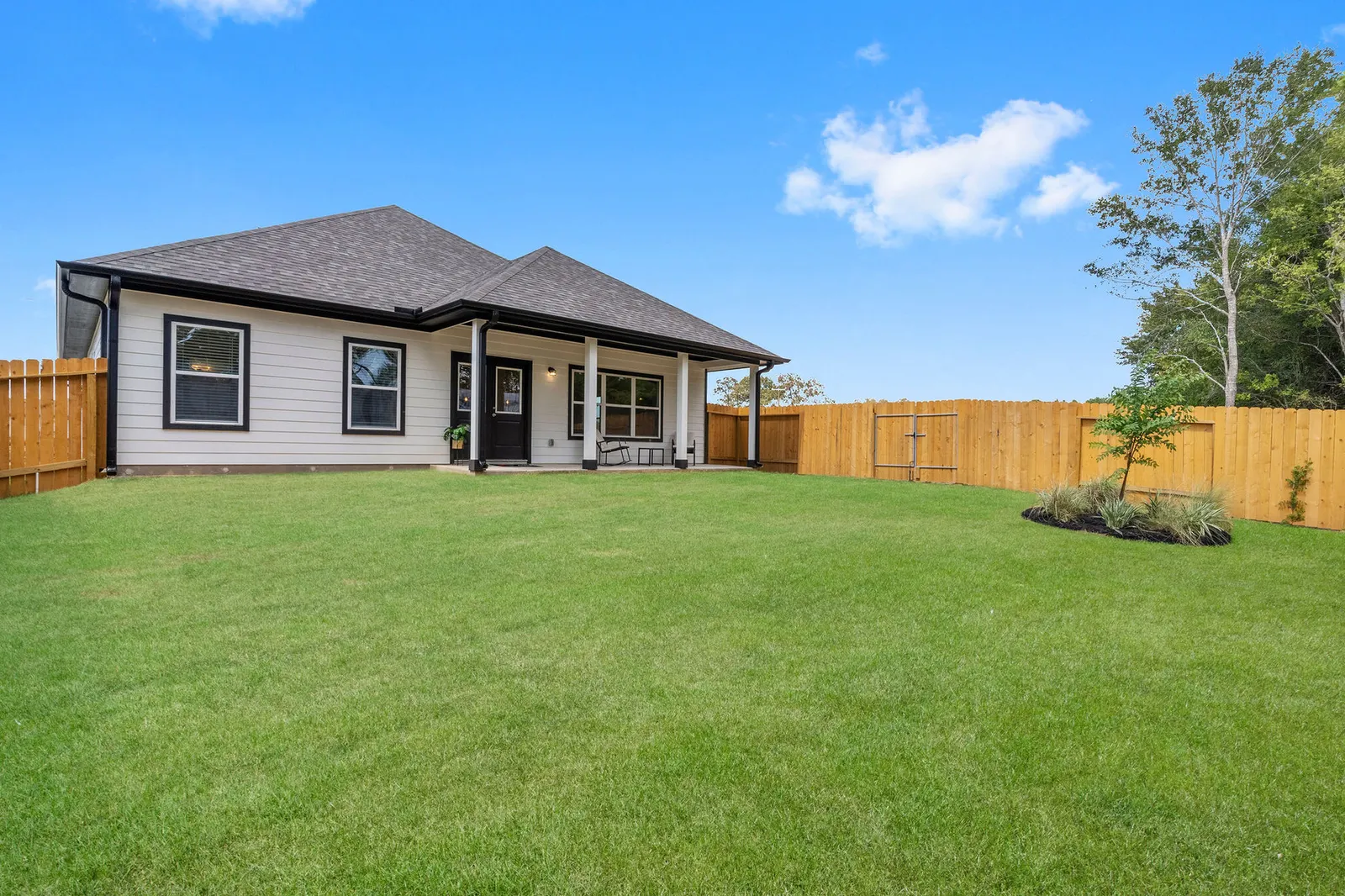 Fenced backyard with a covered rear patio