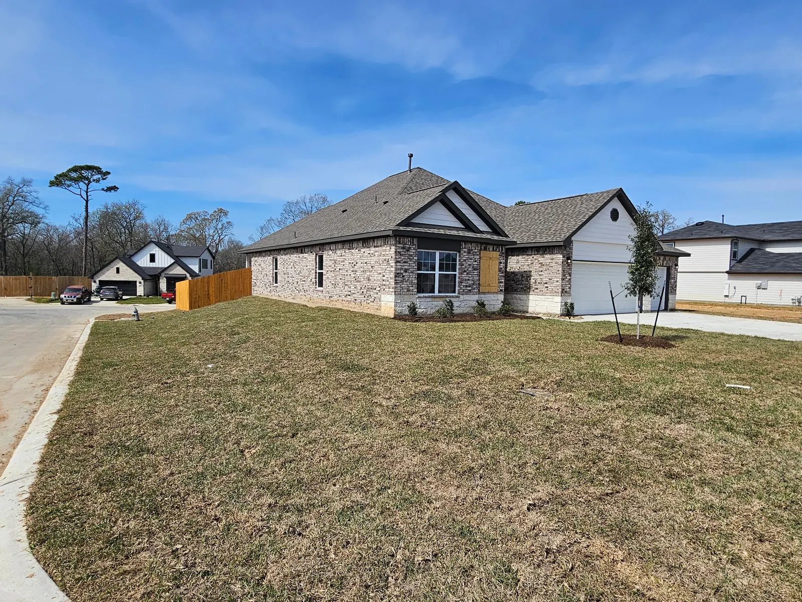 Street view of the front and side elevation at 11803 Serena's Song Drive, Willis, TX