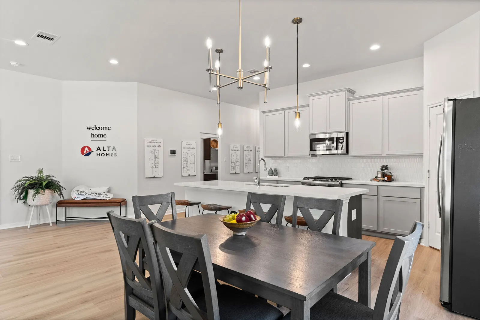 Dining area beside a white kitchen with an island