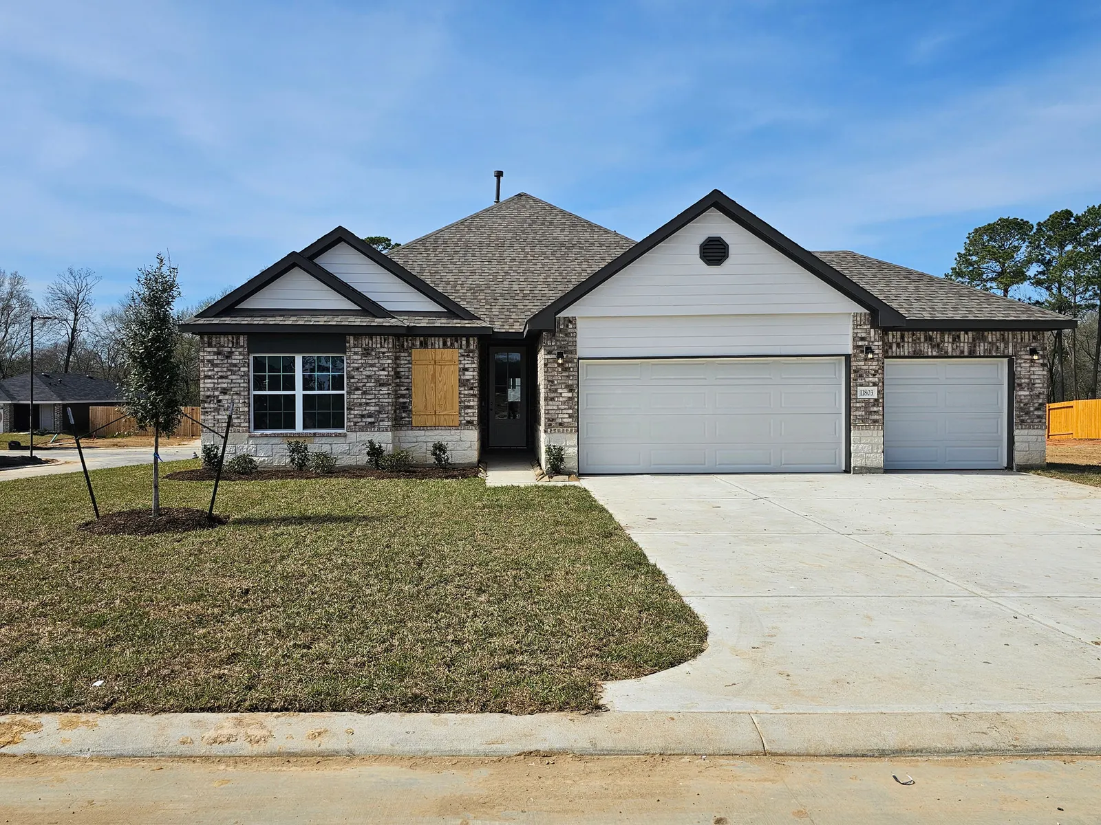 Front exterior with brick and stone at 11803 Serena's Song Drive, Willis, TX