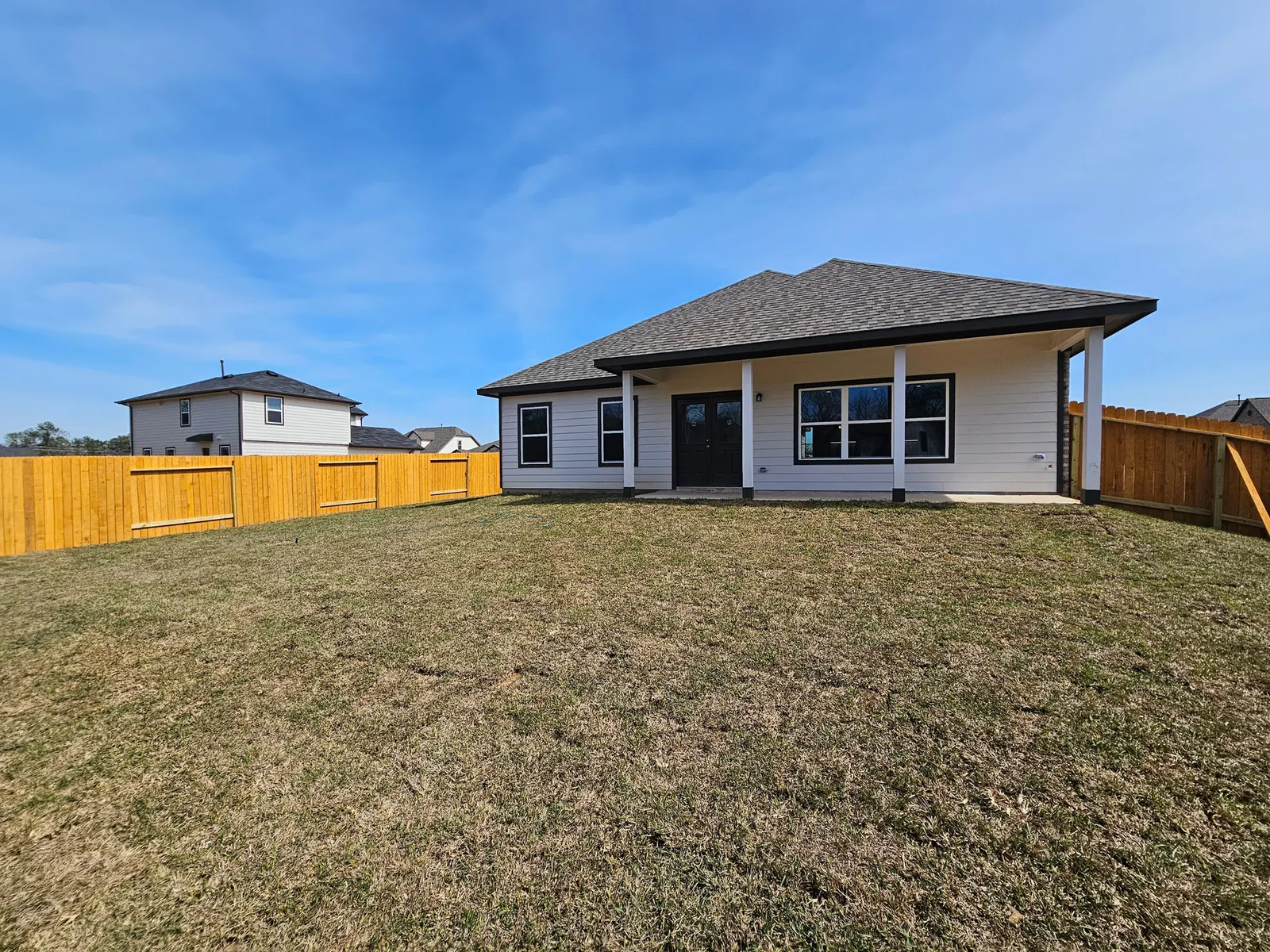 Rear elevation with covered patio at 11803 Serena's Song Drive, Willis, TX